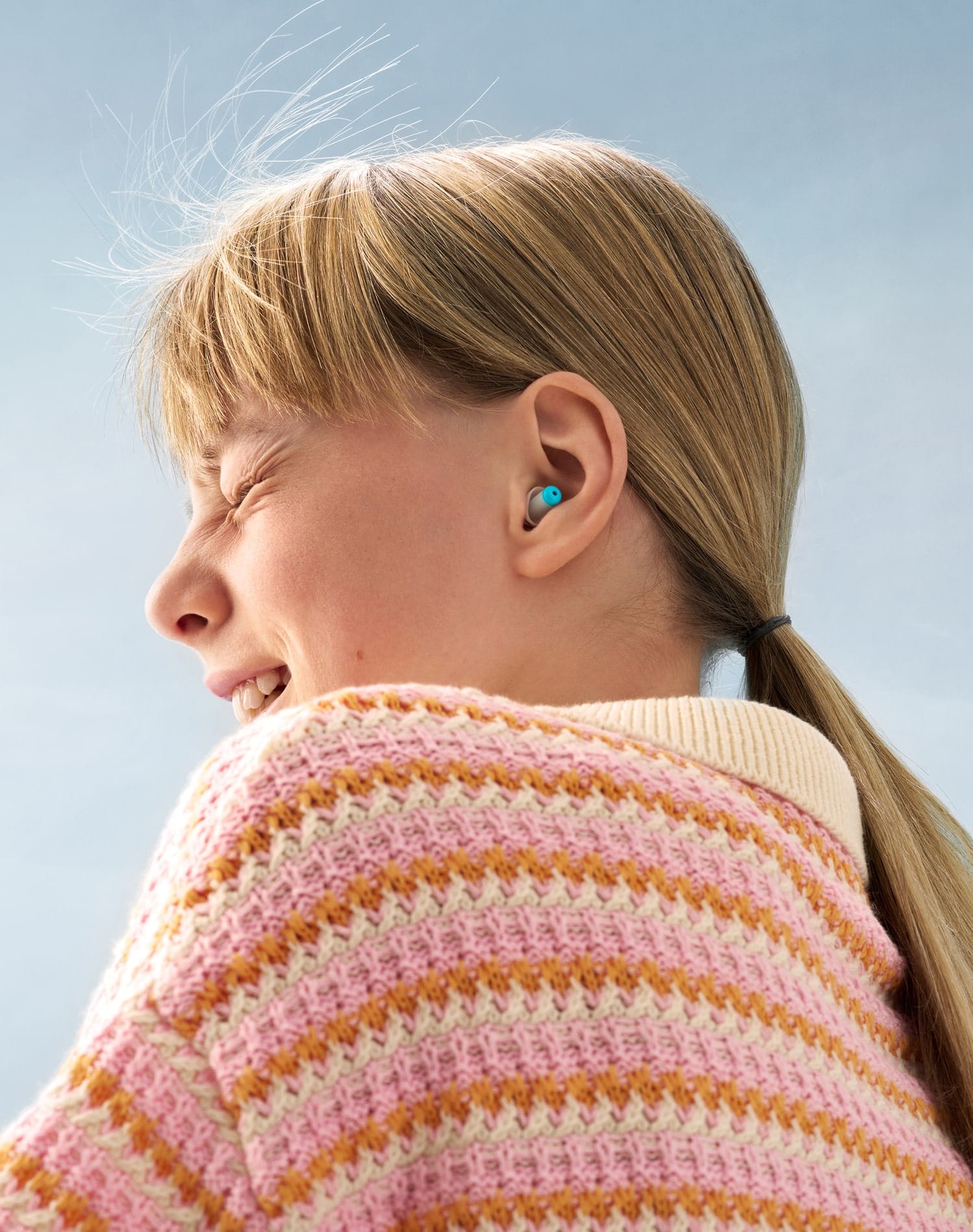 close-up photography of a girl wearing Alpine earplugs