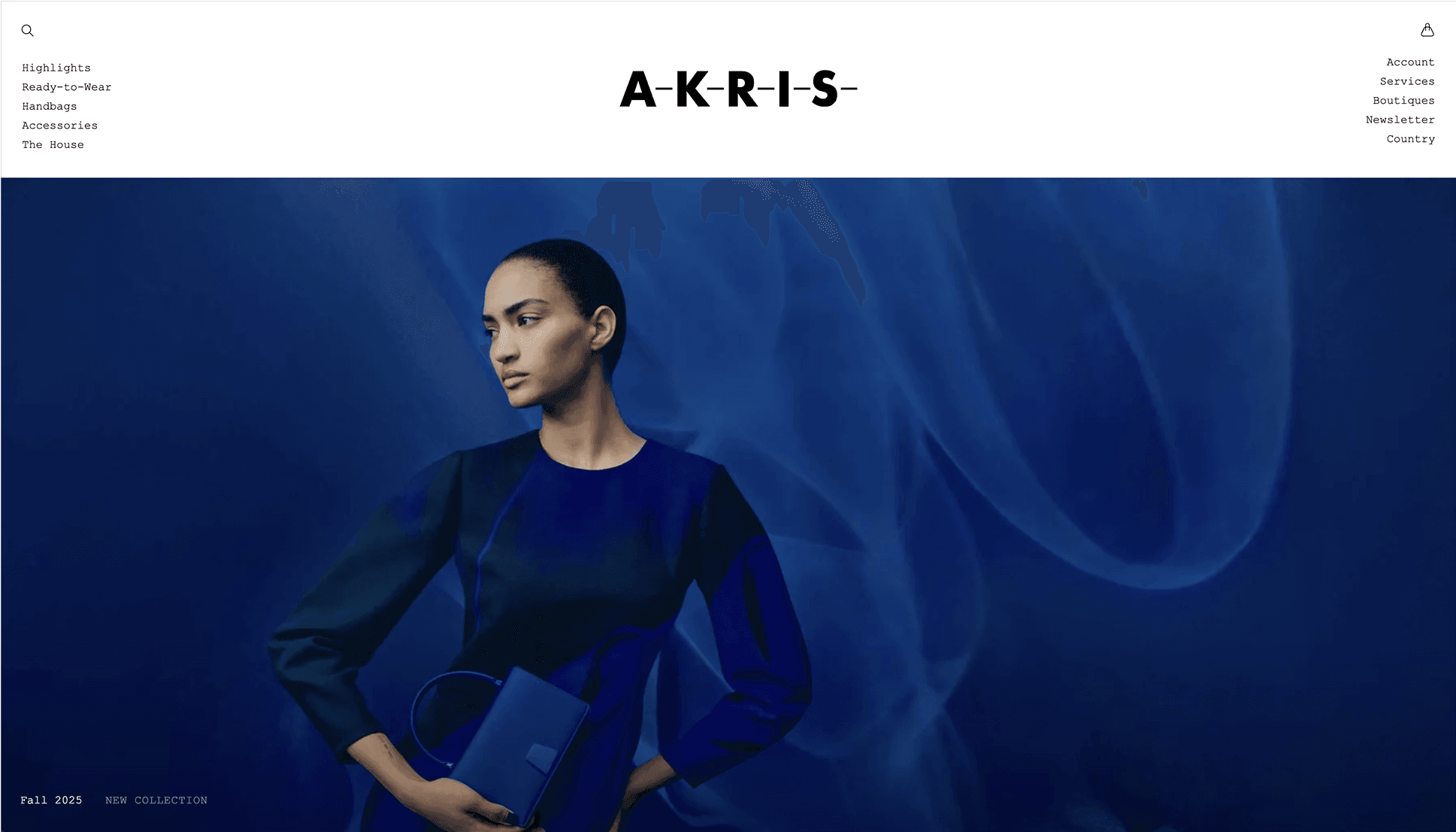 A woman in a blue dress holds a matching clutch against a smoky blue background. A-K-R-I-S logo is above. Links are on the top left.