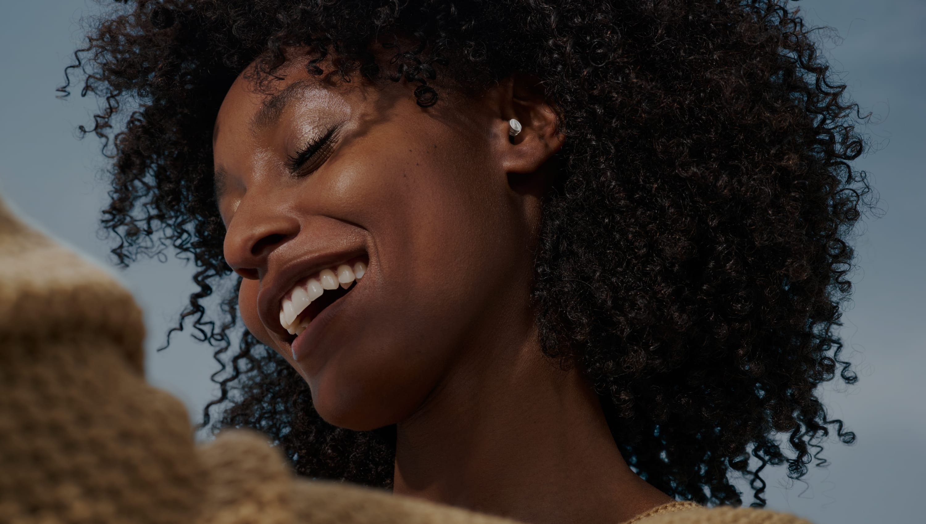Woman dancing while wearing Alpine earplugs