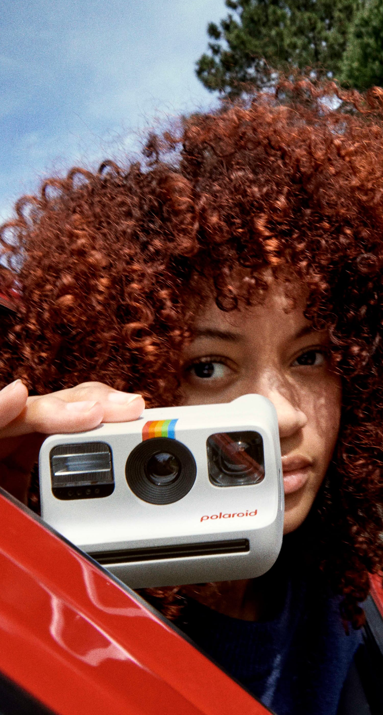 Girl holdina a polaroind camera