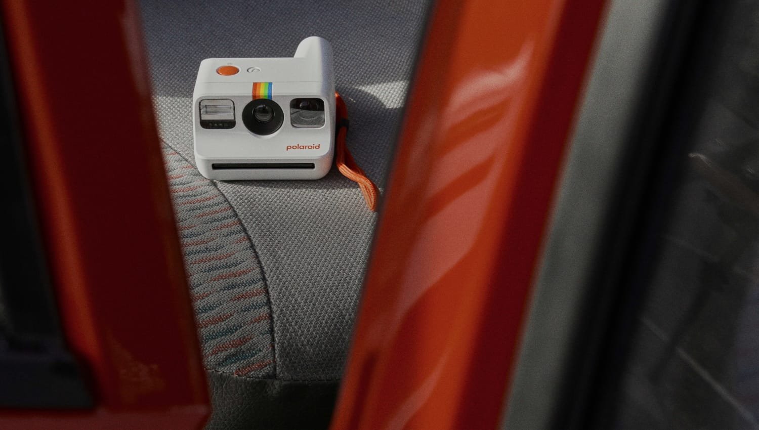 Polarod camera laying on a car backseat